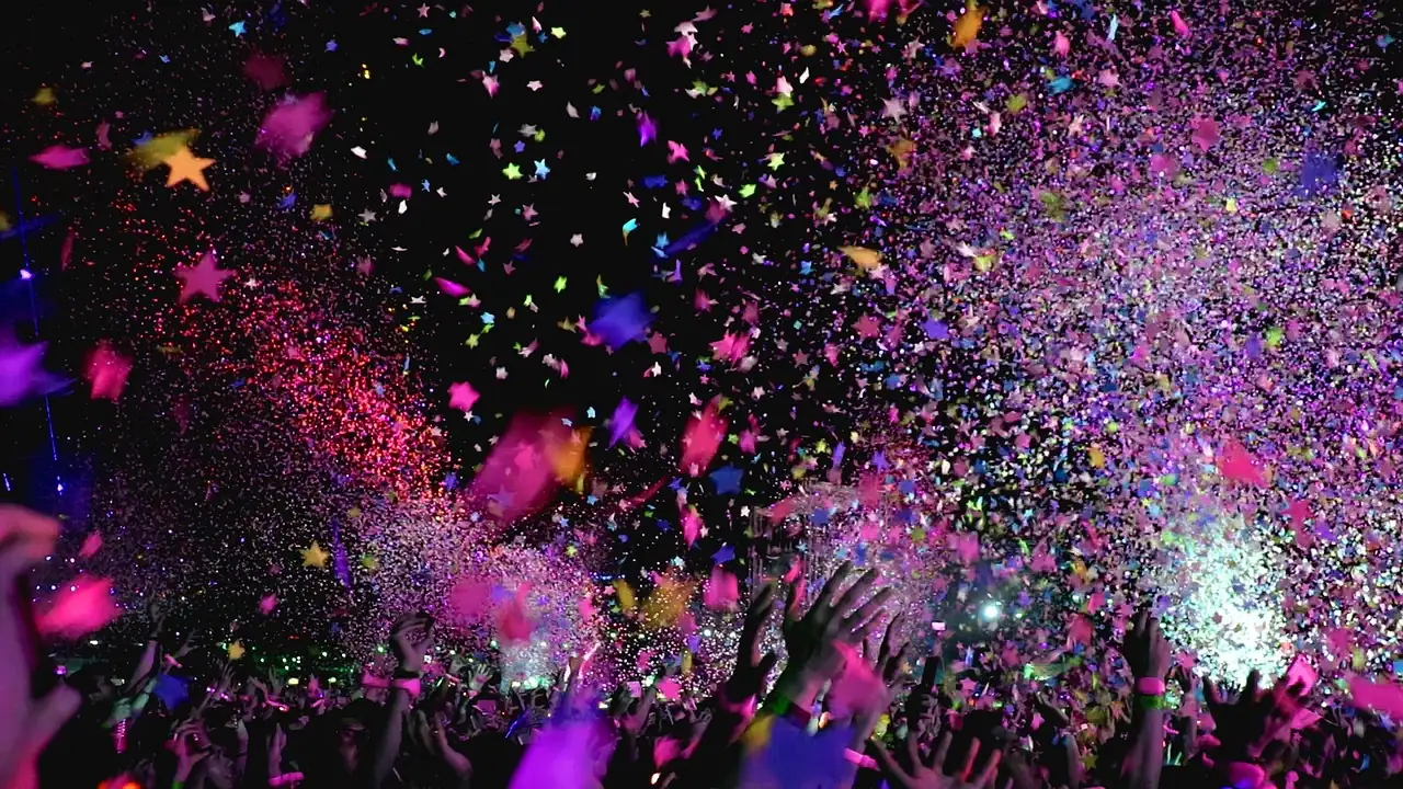 Farewell celebration with colorful confetti and cheering crowd under bright lights