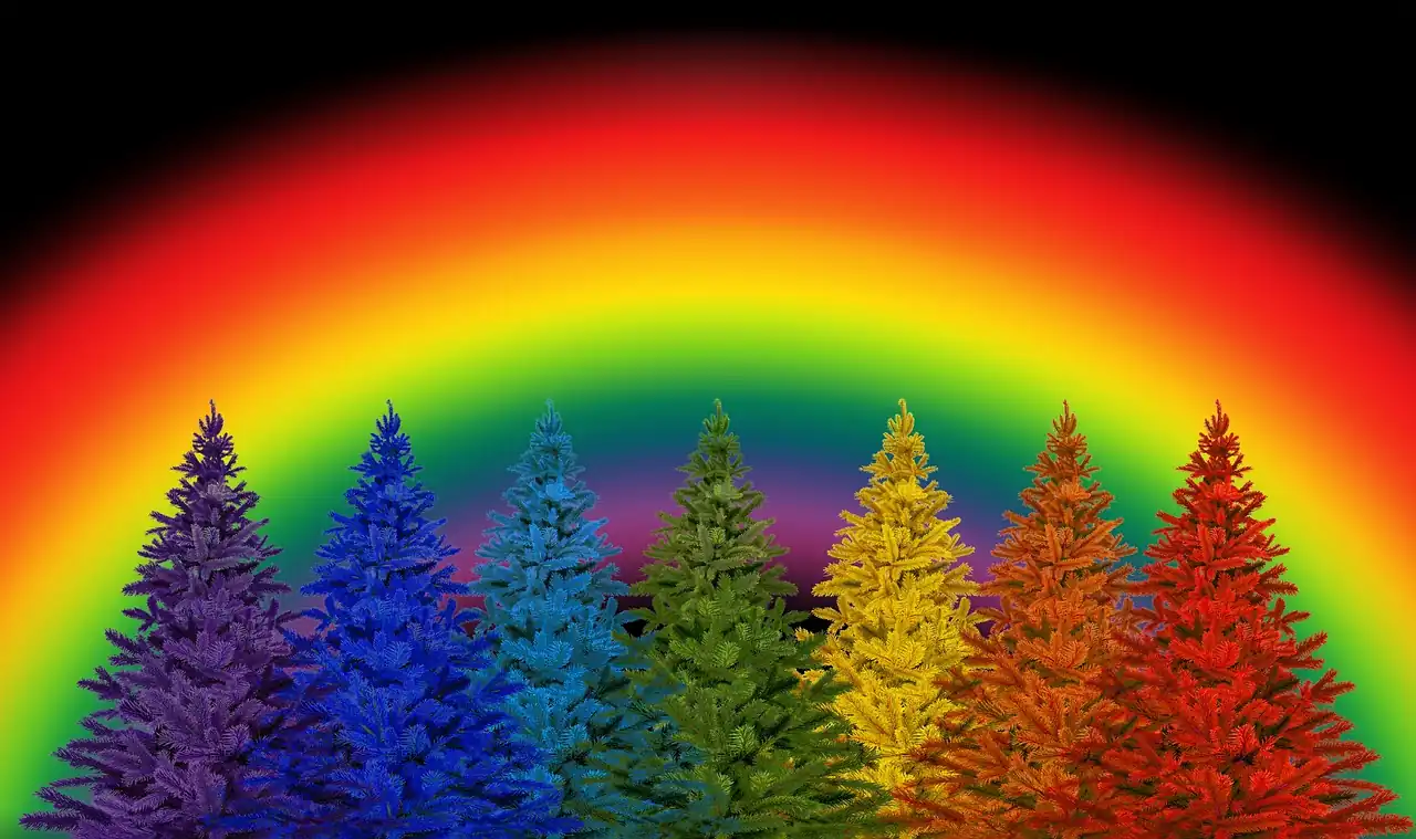 Row of rainbow-colored Christmas trees under a glowing rainbow light, symbolizing joy and wonder