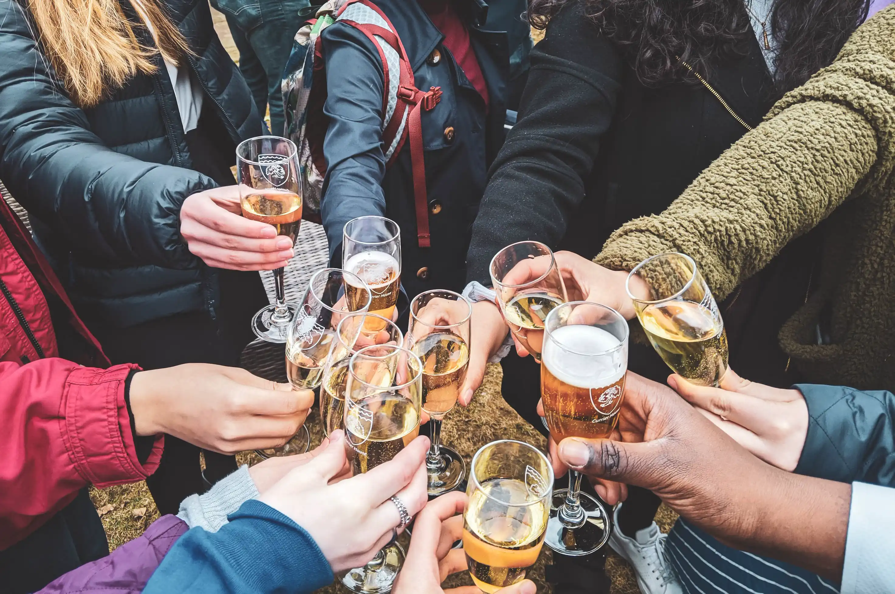 Coworkers raising glasses of champagne in celebration of a work promotion